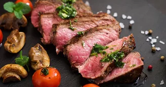Juicy steak medium rare beef with spices and grilled vegetables.